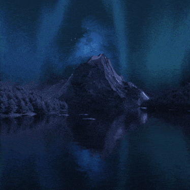 a mountain is reflected in a lake with the aurora borealis in the sky