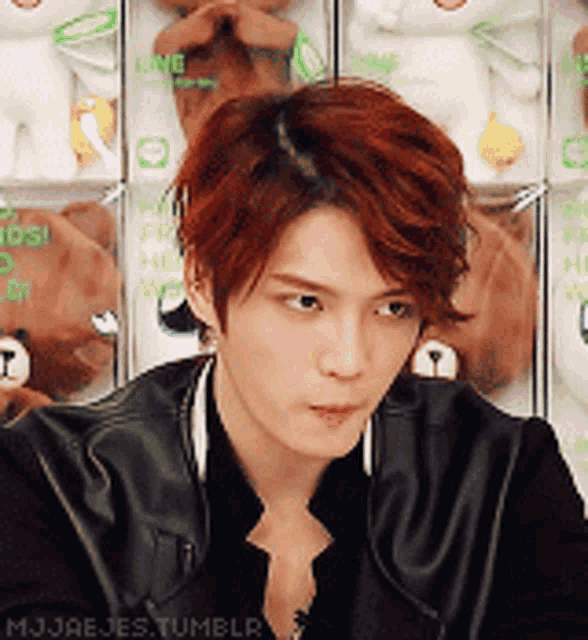 a man with red hair is standing in front of a teddy bear display