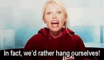 a woman in a red hoodie is screaming and saying `` in fact , we 'd rather hang ourselves '' .