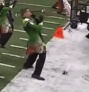 a man in a green uniform is standing in front of a red cone that says 40 on it