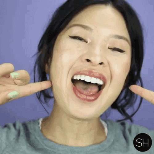 a close up of a woman 's face with sh written on the bottom right