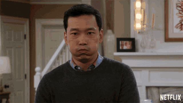 a man is making a funny face in front of a fireplace and a netflix logo