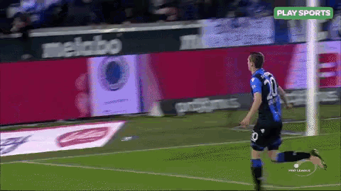 a soccer player with the number 20 on his jersey runs on the field