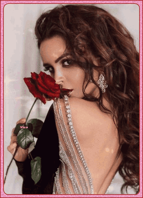 a picture of a woman holding a red rose with vice written on the bottom right