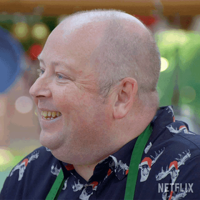 a man wearing a shirt that says netflix is smiling