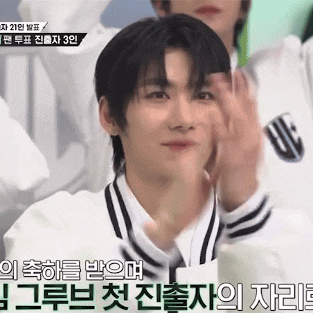 a man in a white shirt with black stripes on the sleeves is clapping