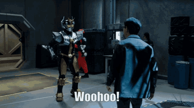 a man in a blue jacket stands in front of a superhero and says woohoo
