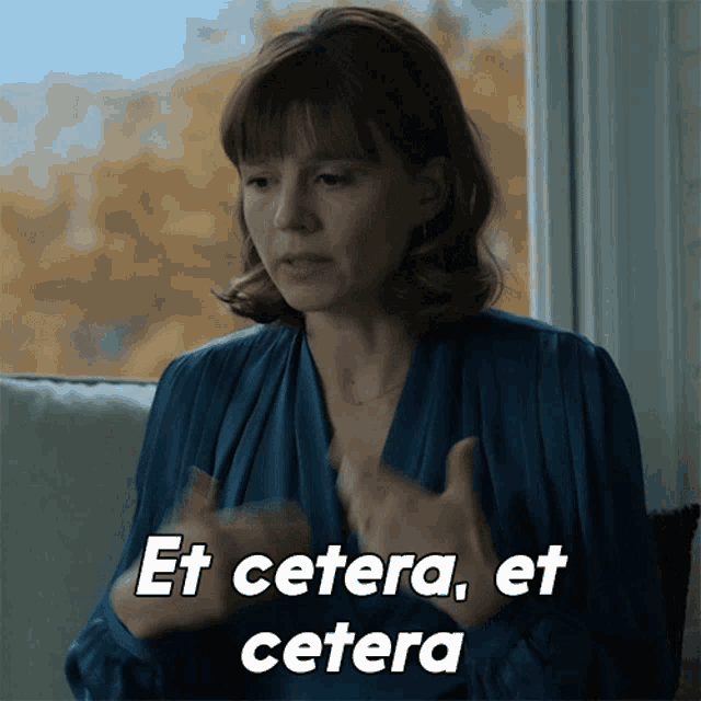 a woman sitting in front of a window with the words et cetera et cetera above her