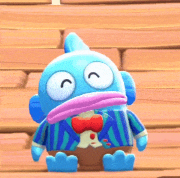 a blue cartoon character wearing a suit and bow tie is sitting on a wooden floor .