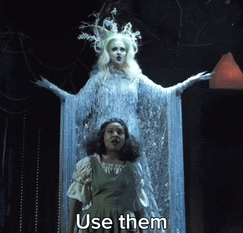 a woman in a green dress is standing in front of a ghost that says use them on the bottom