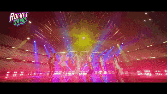 a group of people are dancing on a stage with a rocket gang logo