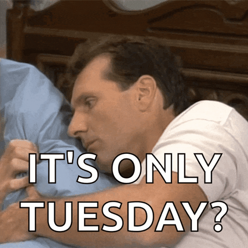 a man laying on a bed with the words " it 's only tuesday " below him