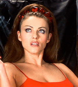 a woman in a red tank top has a red headband on her hair