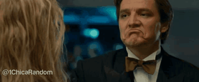 a woman with blonde hair and blue eyes is looking at another woman 's face .