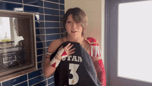 a woman is holding a shirt that says utah 3 on it
