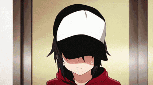 a girl wearing a baseball cap and a red hoodie is covering her face .
