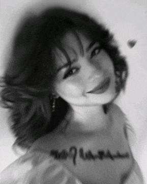 a black and white photo of a woman with a signature on her neck