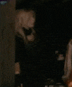 a blurry picture of a person standing in a dark room