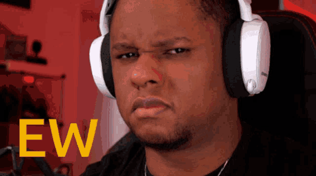 a man wearing headphones has the word ew written in yellow