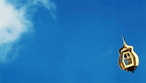 a blue sky with a few clouds and a person in the air