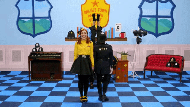 a woman in a yellow shirt is standing in front of a sign that says muggle town police department