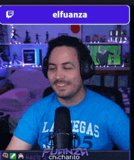 a man wearing headphones and a blue shirt that says las vegas
