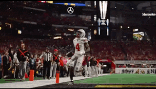a football player with the number 4 on his jersey is running on the field
