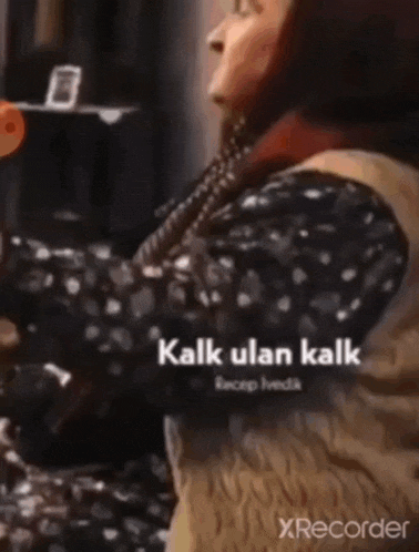 a woman in a polka dot dress is dancing with the words kalk ulan kalk written on the bottom