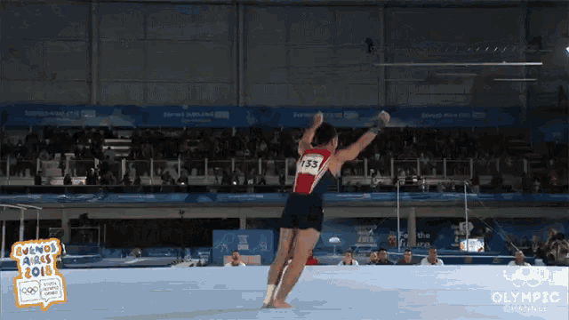 a gymnast with the number 33 on the back of his shirt