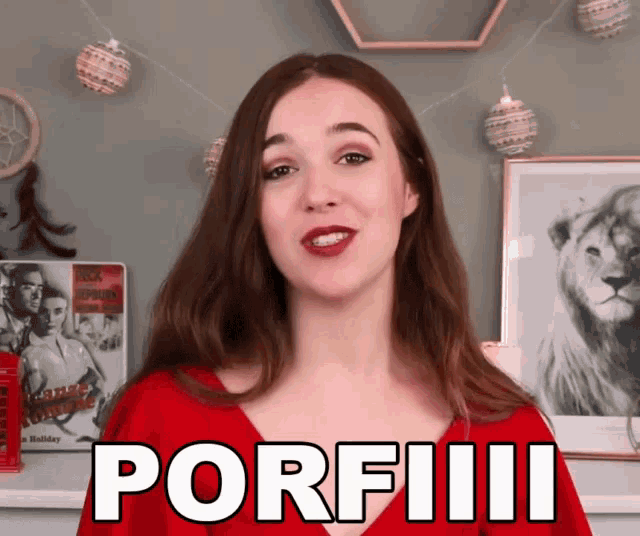 a woman in a red top says porfiiii in front of a picture of a lion