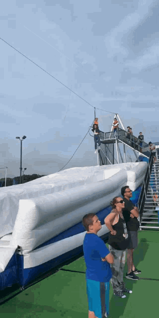 a group of people standing in front of a large inflatable object