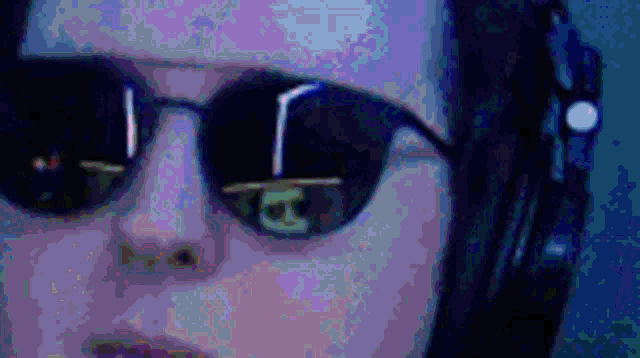 a close up of a person wearing headphones and sunglasses