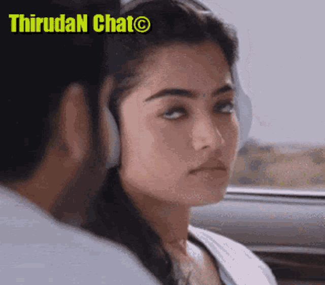 a woman wearing headphones is looking at a man