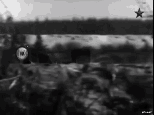 a black and white photo of a red star in the sky