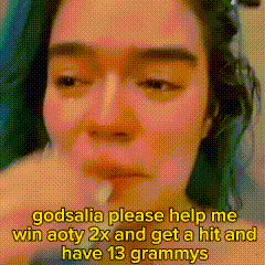 a woman with blue hair is crying and asking godsalia to help her win aoty 2x