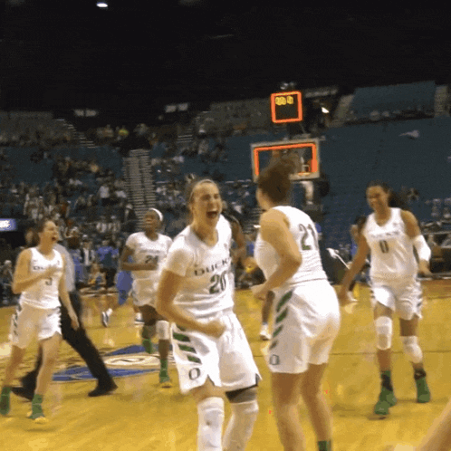 a group of female basketball players with one wearing a jersey that says duck