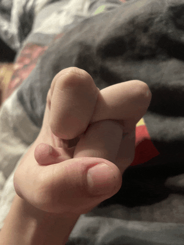 a close up of a person 's hand with their fingers together