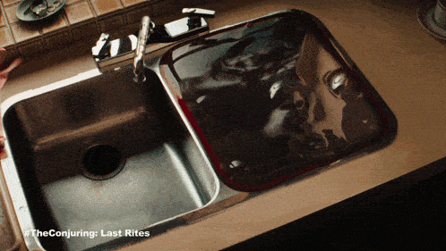 a picture of a kitchen sink with the conjuring last rites on the bottom