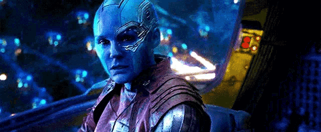 nebula from guardians of the galaxy is sitting in the cockpit of a space ship looking out the window .
