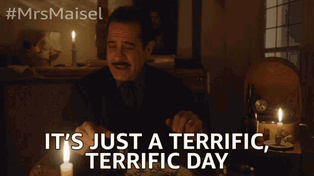 a man sitting at a table with candles and the words it 's just a terrific terrific day on the bottom