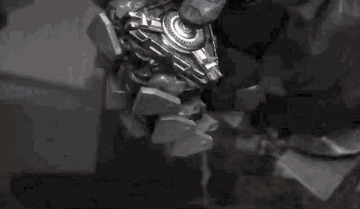 a close up of a statue of a robot with a lot of pieces of metal coming out of it .