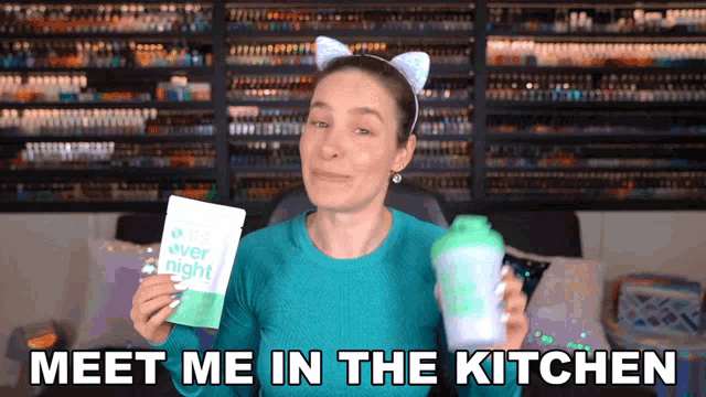 a woman holding a bag of over night and a shaker with the words meet me in the kitchen below her