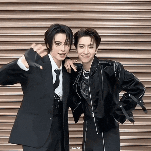two men posing for a picture with a gif written on the bottom right