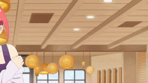 a girl with red hair and a blue necklace is smiling in a room with lanterns hanging from the ceiling