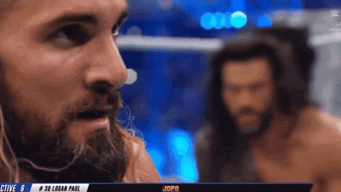 a man with a beard is standing next to another man with a beard .