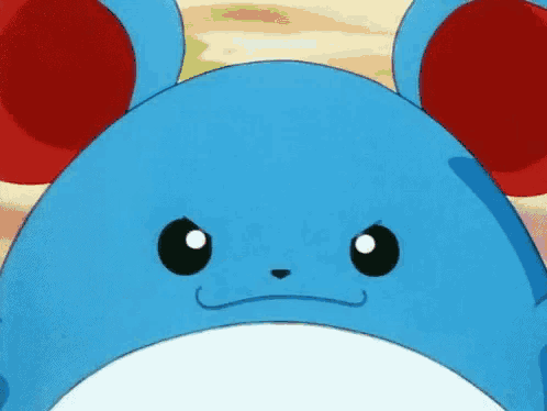 a close up of a blue and red cartoon character 's face