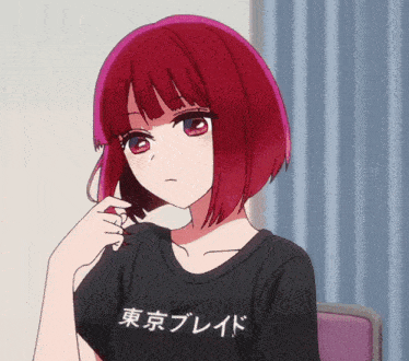 a girl with red hair is wearing a black t-shirt with japanese writing on it