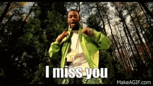 a man in a green jacket is dancing in the woods and saying `` i miss you '' .