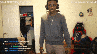 a man wearing headphones stands in front of a screen that says wale followers 528/530