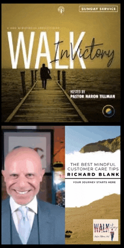 a man in a suit and tie is smiling next to a book titled walk in victory